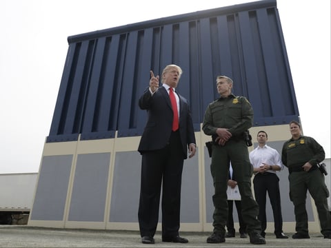 President Donald Trump reviews border wall prototypes, Tuesday, March 13, 2018, in San Diego.