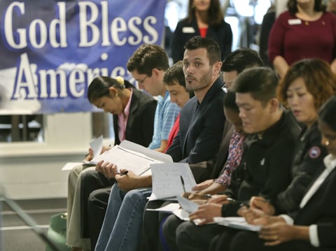 Newly naturalized U.S citizens complete voter registration forms in Bethel Park, Pa., in November 2017. The 2020 census will ask respondents whether they are citizens.
