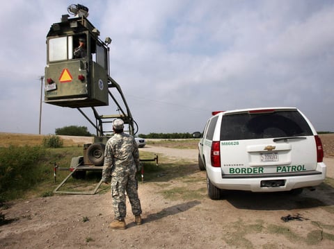 A member of the National Guard checks on his colleague inside a Border Patrol Skybox near the U.S.-Mexico border in Hidalgo, Texas, in 2011.