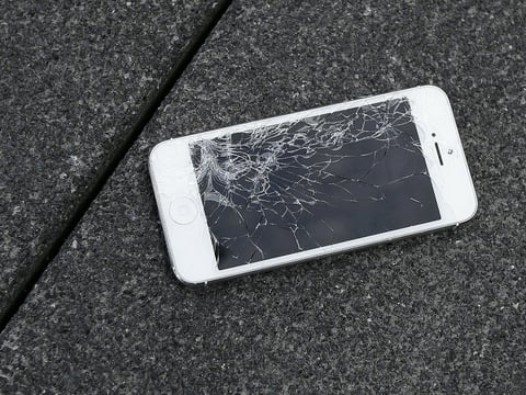 This Aug. 26, 2015, file photo shows an Apple iPhone with a cracked screen after a drop test at the offices of SquareTrade in San Francisco. 