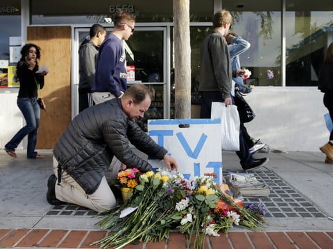 In this May 24, 2014 file photo, Stephen Nichols arranges flowers left where part of a mass shooting took place by Elliot Rodger in Isla Vista, Calif. Rodger has become a symbol for an online community of young male supremacists called 'incels'.