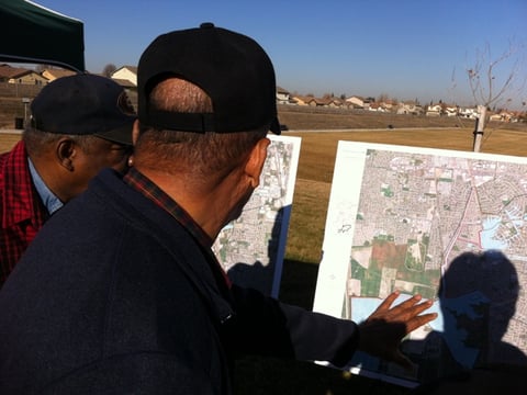 Willie Caston and Sammie Batton look at new FEMA flood map to see where there homes are relative to areas still considered in high-risk flood zones.