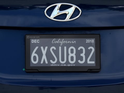A digital license plate made by Bay Area company Reviver Auto is displayed at the company's headquarters on May 30 in Foster City, Calif. The plates have the ability to track cars and play ads.