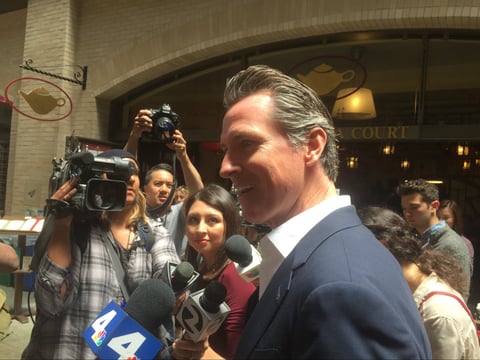 Gavin Newsom greeting supporters and taking media questions at the San Francisco Ferry Building.