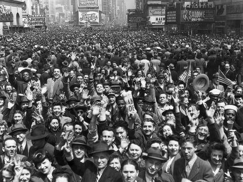 An enormous New York crowd celebrates VE Day at the end of WWII. Aaron Copland was inspired to write his "Fanfare for the Common Man" by a wartime speech rallying Americans against imperialism.