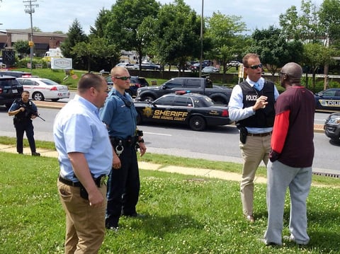 Police officers talk to a man as they respond to an active shooter at Maryland's Capital Gazette newspaper in Annapolis on Thursday.
