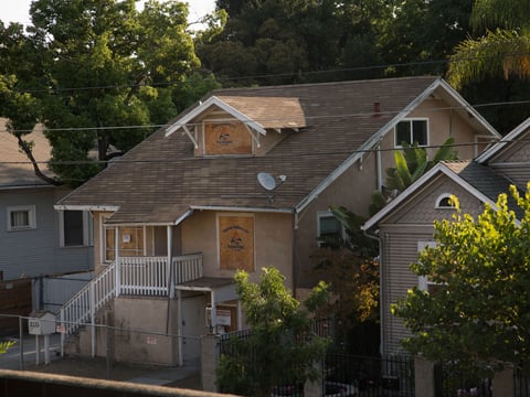 The windows on this house in the Oak Park area of Sacramento have been boarded over.