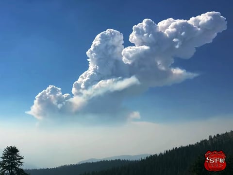 This Sunday, July 15, 2018 image from video provided by Sierra Fire Watch shows a large fire and smoke plume rising over an area northwest of Yosemite National Park as the Ferguson fire continues to spread in California's Sierra Nevada.