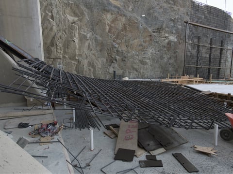 The diagonal steel braces like those seen on the structure in the back were inadequate to hold the temporary rebar structure in place. 