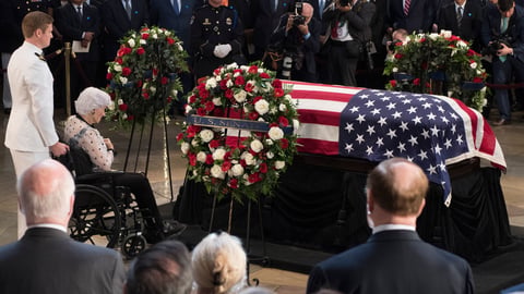 Roberta McCain, mother of John McCain, pays respects before his flag-draped casket Friday at the Capitol rotunda. His final public memorial is Saturday at the National Cathedral.