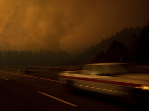 A fire vehicle drives along Interstate 5 as the Delta Fire burns in the Shasta-Trinity National Forest, Calif., on Thursday, Sept. 6, 2018.