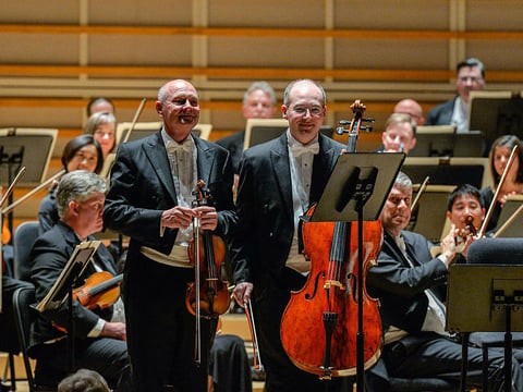 Violinist William Preucil (left), taking a bow with the Cleveland Orchestra at a 2016 performance in Miami.