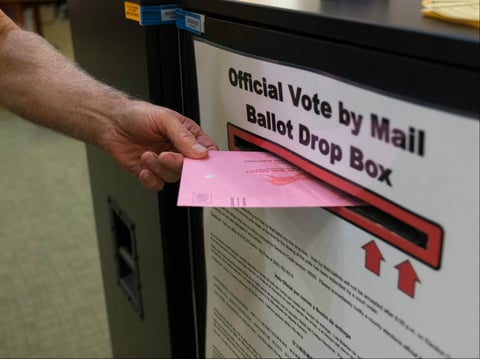 A voter submits their ballot at Carmichael Library in Carmichael, Calif. on October 22, 2018.
