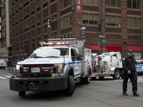 A police truck tows a total containment vessel to a post office in midtown Manhattan to dispose of a suspicious package, Friday, Oct. 26, 2018, in New York.