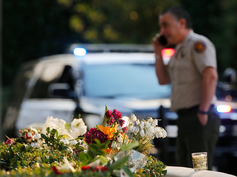 A bouquet of flowers, left by mourners, lays near the site of Wednesday's mass shooting, in Thousand Oaks, Calif., Friday, Nov. 9, 2018.