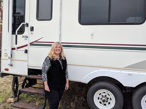 Kelley Conner stands outside the used RV she bought after the Camp Fire destroyed her home in Magalia, just north of Paradise, California.