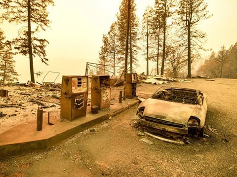 A burned car and a gas station remain visible after the Camp Fire tore through the region near Pulga, east of Paradise, California, on Nov. 11, 2018.