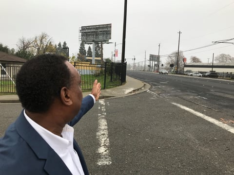 Tyrone Roderick Williams SHRA pointing to area between Richards and Eliza Street where a new light rail station will be installed.