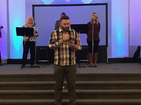 Youth pastor Kyle Smith of First Assembly of God Paradise reads from the Bible on his phone because his copy of the book burned in the Camp Fire. His congregation is one of several now worshiping with congregations in Chico.