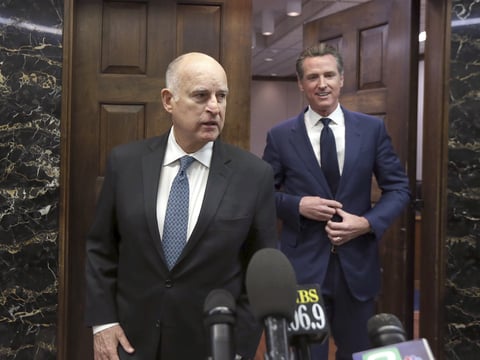 California Gov. Jerry Brown, left, and Governor-elect Gavin Newsom emerge from the Governor's office to talk with reporters after meeting at the Capitol. Newsom will be sworn into office Monday, Jan. 7, 2019.
