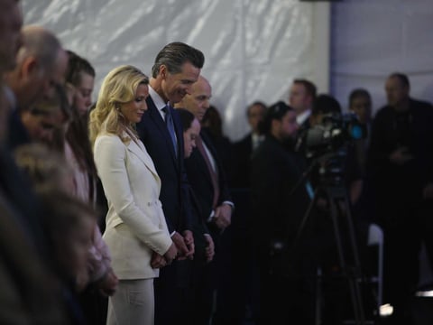 Gov. Gavin Newsom and First Partner Jennifer Siebel Newsom join in a prayer for the incoming governor at Newsom's inauguration on Jan. 7, 2019.