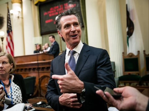 Gov. Gavin Newsom speaks to reporters on the floor of the Assembly chambers on December 3, 2018 at the State Capitol in Sacramento, California.