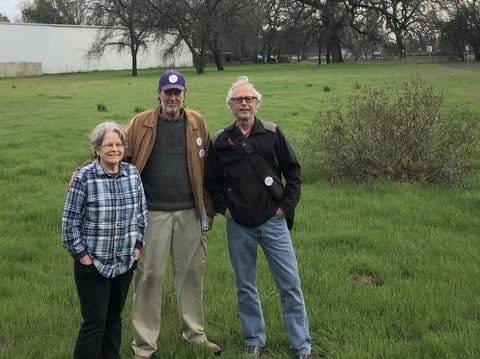 Chico Housing Action Team organizers Leslie Johnson, left, Charles Withuhn, center, and Bill Kurnizki, right, in the field in south Chico where they plan to soon break ground on a 33-unit tiny home community for homeless adults.