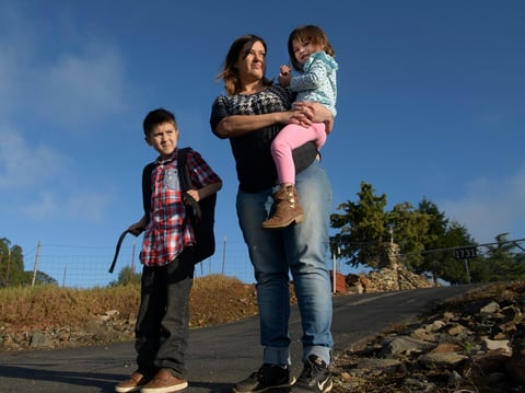 Jeanny Morris, an El Dorado Hills mother of two whose for-profit college investment left her unemployed and $22,000 in debt. Here she waits at the school bus stop with son Ethan, 9, and daughter Mia, 4.