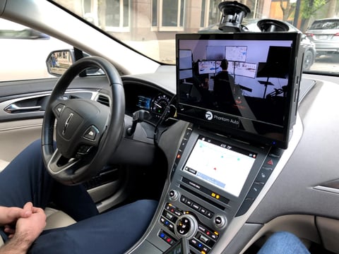 If you hop in a car equipped with technology from Phantom Auto, you’ll hear a driver. But they’re not inside the car. Instead, they control it from a facility 100 miles away.