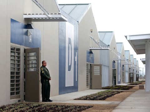 In this June 25, 2013 file photo, a correctional officer stands outside of one of the secure housing units at the new California Correctional Health Care Facility in Stockton, Calif., during dedication day festivities.