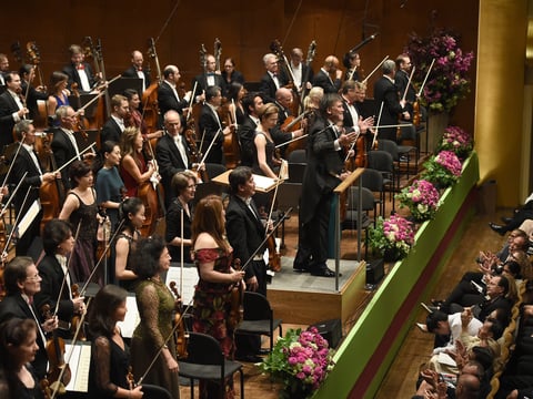Members of the New York Philharmonic, led by music director Alan Gilbert, during the opening of a new season on September 21, 2016 in New York.