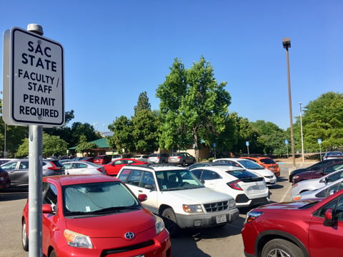 Labor contracts require CSU employees to pay less for parking than students.