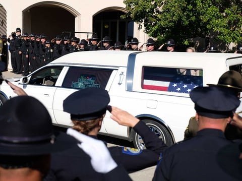A hearse carrying the body of Sacramento Police Officer Tara O'Sullivan pulls up outside the Bayside Church's Adventure Campus in Roseville.