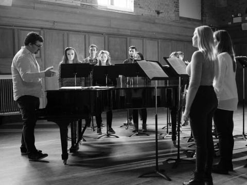 Artistic director Desmond Earley, left, leads the Choral Scholars of University College Dublin in rehearsal.