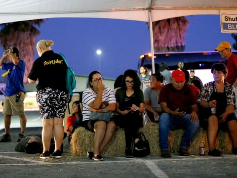 Ana Lilia Cano, left, with daughter Paulina Perez, and Gildardo Leyva, right, wait for relatives at a reunification center at Gavilan College following a shooting at the Gilroy Garlic Festival, in Gilroy, Calif., Sunday, July 28, 2018.