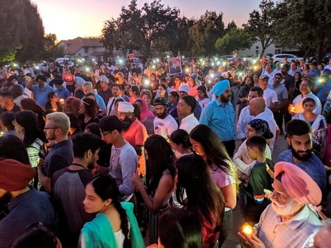People gather at a candlelight prayer vigil for Parmjit Singh in Gretchen Talley Park, in Tracy, Calif., on Aug. 28, 2019. Singh was wearing his traditional turban when he was fatally stabbed in the park.