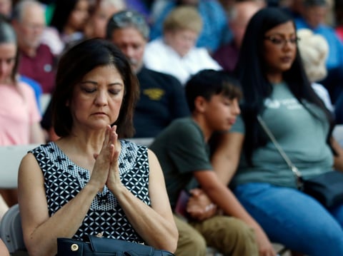 Mira Marquez, of Midland, Texas, folds her hands in prayer during a prayer service, Sunday, Sept. 1, 2019, in Odessa, Texas, for the victims of a shooting spree the day before.