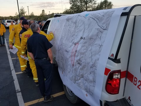Cal Fire crews check the map of the Swedes Fire Sunday, Sept. 8, 2019.
