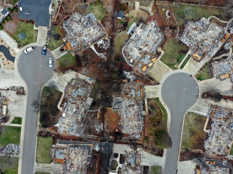 PG&E says it will pay $11 billion to resolve insurance companies' claims from the 2017 Northern California wildfires and the 2018 Camp Fire. Here, destroyed homes are seen in Paradise, Calif., where the Camp Fire raged last November.