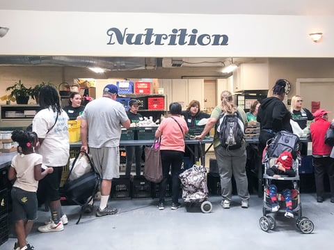 People pick up produce, canned goods, meat, dairy and bread at the River City Food Bank in Sacramento.
