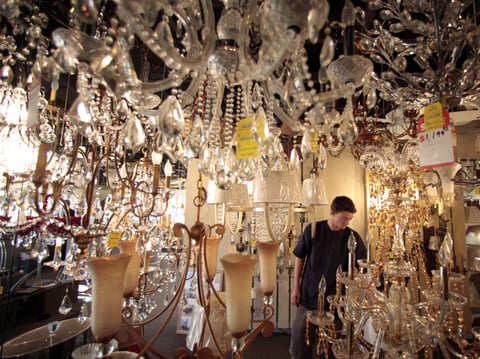 Jack George, an employee at Royal Lighting, looks at chandeliers using incandescent light bulbs at the store in Los Angeles. A federal judge is allowing California to enforce updated efficiency standards that will affect such specialty lightbulbs.