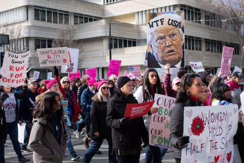 Women's March demonstrators march on the Calif. State Capitol.