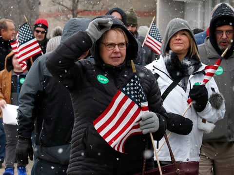 People wait on line in the snow to see Democratic presidential candidate Sen. Amy Klobuchar, D-Minn., at a campaign event, Sunday, Feb. 9, 2020, in Nashua, N.H.