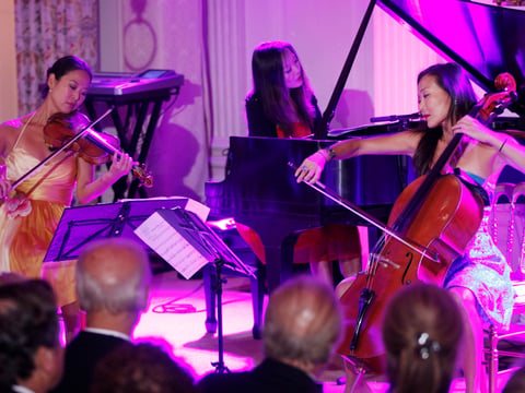 The Ahn Trio, with Angella Ahn on violin, Lucia Ahn on piano, and Maria Ahn on cello, perform for President Barack Obama and South Korean President Lee Myung-bak at the State Dinner at the White House, Thursday, Oct. 13, 2011.