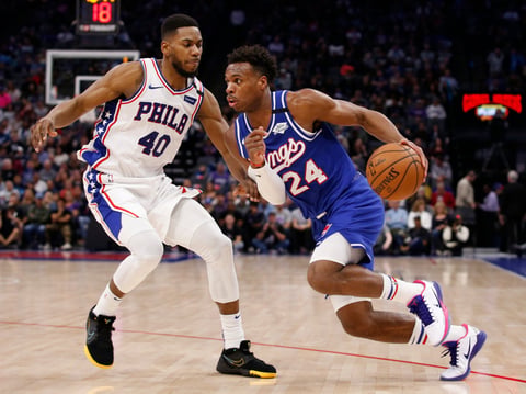 Sacramento Kings guard Buddy Hield, right, drives against Philadelphia 76ers forward Glenn Robinson III during the second half of an NBA basketball game in Sacramento, Calif., Thursday, March 5, 2020.