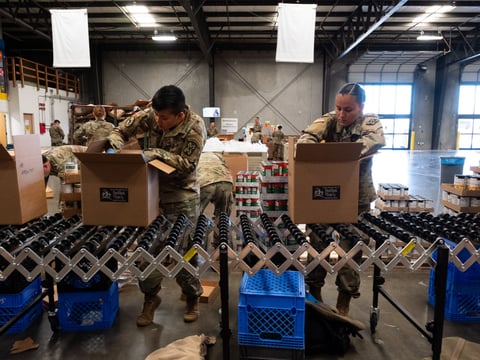 Specialists Neslyn Cubangbang of San Pablo and Yadira Izaguierre of Riverside pack boxes for Sacramento Food Bank and Family Services clients.