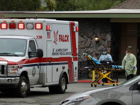 EMT's move a stretcher at the Gateway Care and Rehabilitation Center on Thursday, April 9, 2020, in Hayward, Calif.