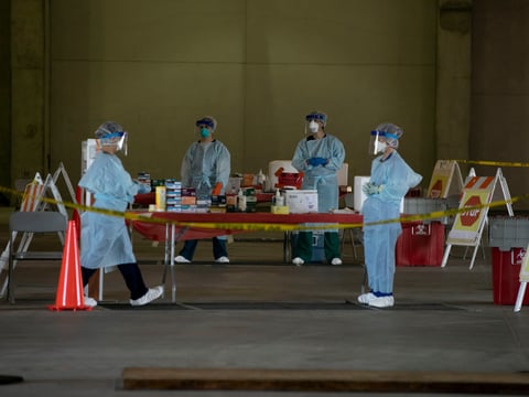 Nurses in PPE wait for patients in the testing bays—called ‘the hot zone’— at a drive-thru COVID-19 testing facility at Cal Expo in Sacramento. The by-appointment-only facility has been testing upwards of 300 patients per day.