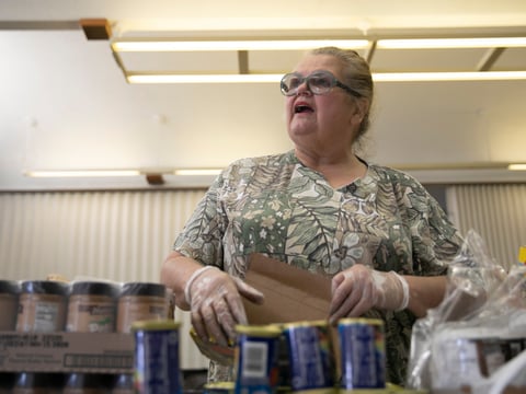 Food bank volunteer Emogene Thomas, 68, arranges cans on a table at Teamsters 315 Hall in Martinez on March 19, 2020. The food bank serves seniors but had about half regular the number of visitors due to coronavirus concerns.