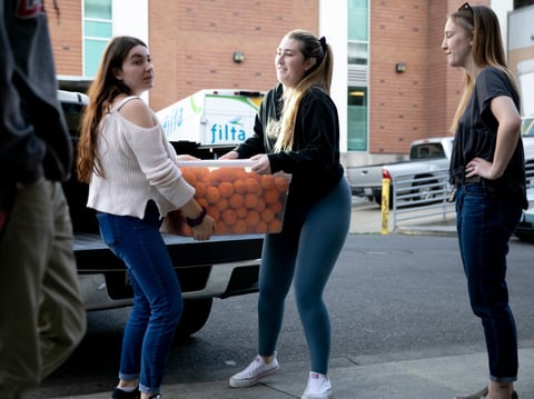 Students deliver a produce donation to the basic needs center at Chico State University on February 12, 2020. The hunger relief organization Feeding America brought food to the center weekly in the aftermath of the Camp Fire.